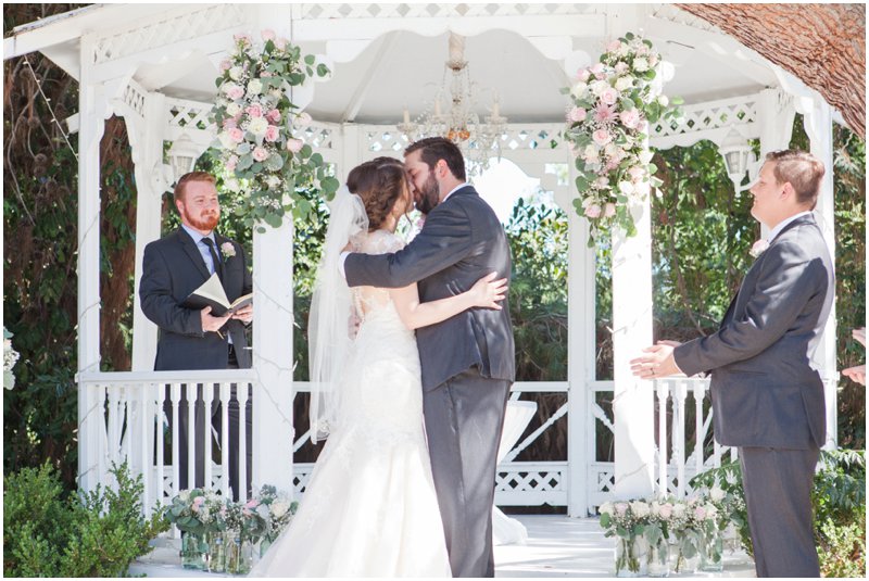bride and groom first kiss in gazebo Green Gables Estate weddings Carrie Mcguire photography Temecula San Diego wedding photographer Temecula winery photographer wedding Temecula wedding photographer Carrie Mcguire photography romantic San Diego garden estate