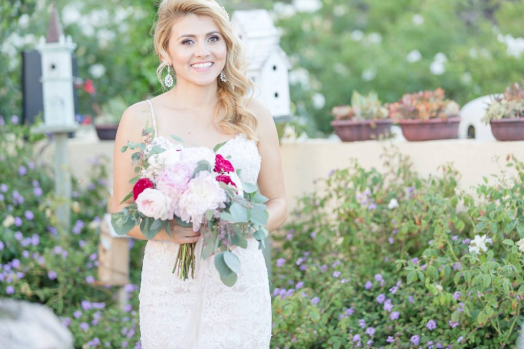 bride with bouquet in garden Forever and always Farm Johnathan and Bernice Temecula wedding photographer Carrie McGuire Photography