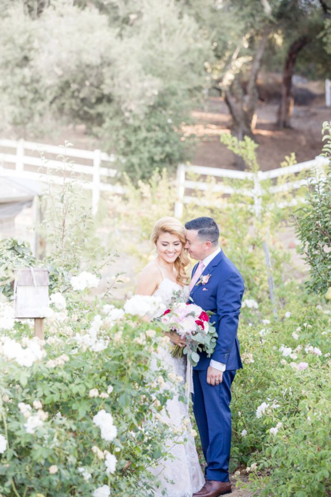 groom and a bride in a garden Forever and always Farm Johnathan and Bernice Temecula wedding photographer Carrie McGuire Photography