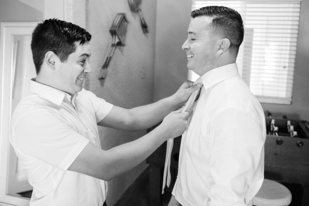 groom and groomsman helping Forever and always Farm Johnathan and Bernice Temecula wedding photographer Carrie McGuire Photography