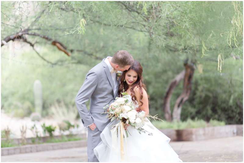 Carrie McGuire photography Temecula photographer Bride and groom embrace with bouquet Tucson Arizona Wedding photographers