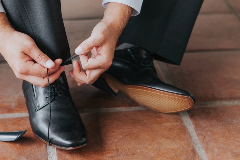 groom tying the shoes Carrie McGuire Photography Temecula Wedding Photography Ponte Inn and Winery 