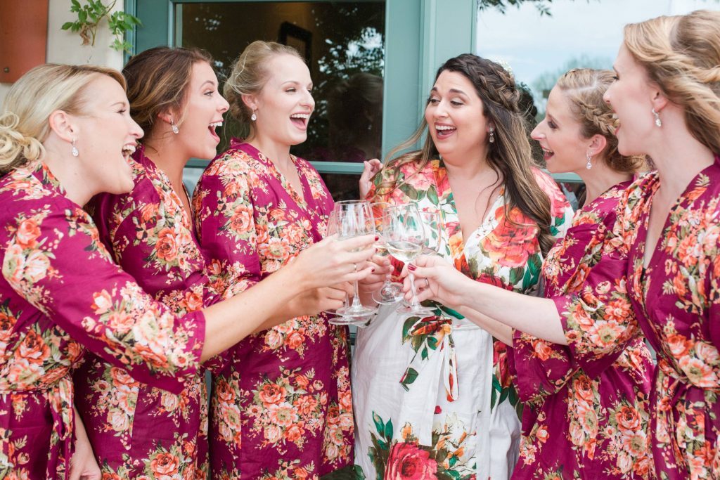 brides and bridesmaids having champagne robe party Carrie McGuire Photography Temecula Wedding Photography Ponte Inn and Winery 