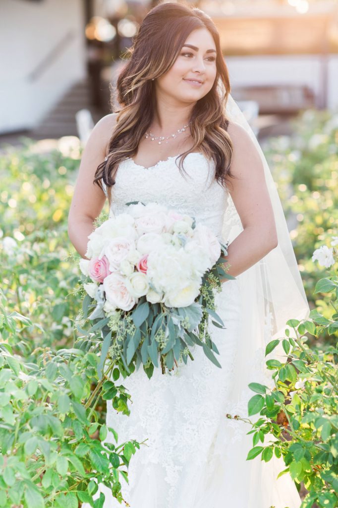 Beautiful bride in garden with bouquet Lakehouse San Marcos Carrie McGuire Photography Temecula Wedding Photography