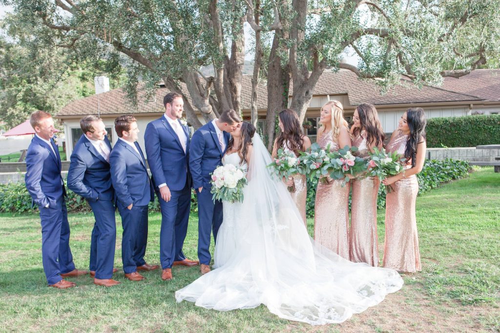Bridal party with groom and bride kissing Lakehouse San Marcos Carrie McGuire Photography Temecula Wedding Photography
