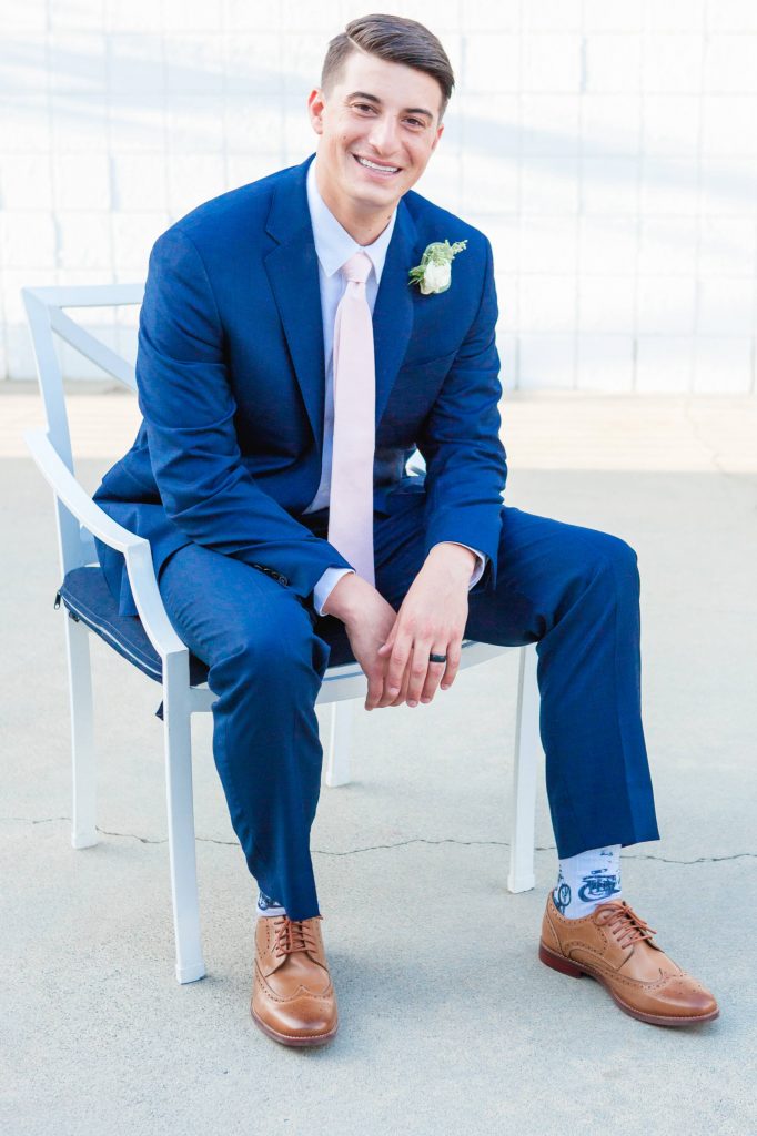 handsome groom in chair Lakehouse San Marcos Carrie McGuire Photography Temecula Wedding Photography
