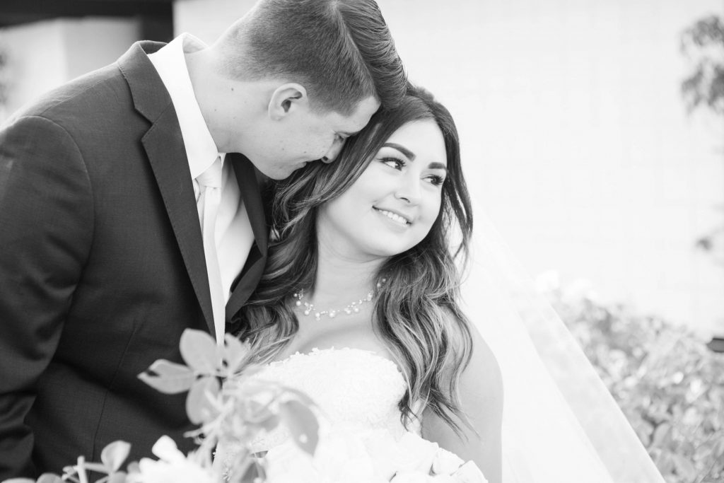 black and white photo of bride and groom in garden Lakehouse San Marcos Carrie McGuire Photography Temecula Wedding Photography