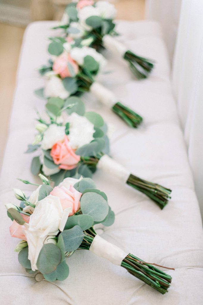 Bridesmaids bouquets laying on the bench at forever and always farm