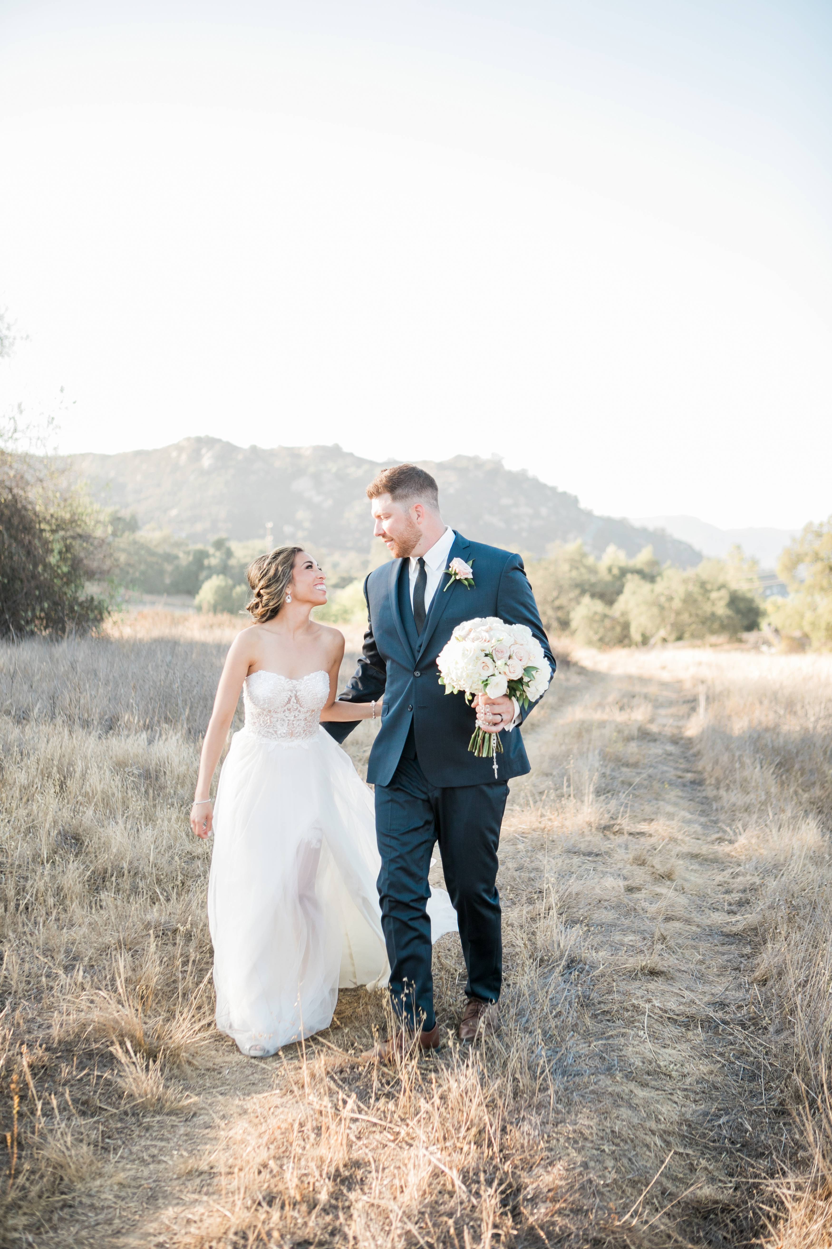 Bride and groom in the field at sunset at Forever and Always Farm wedding venue in Temecula California