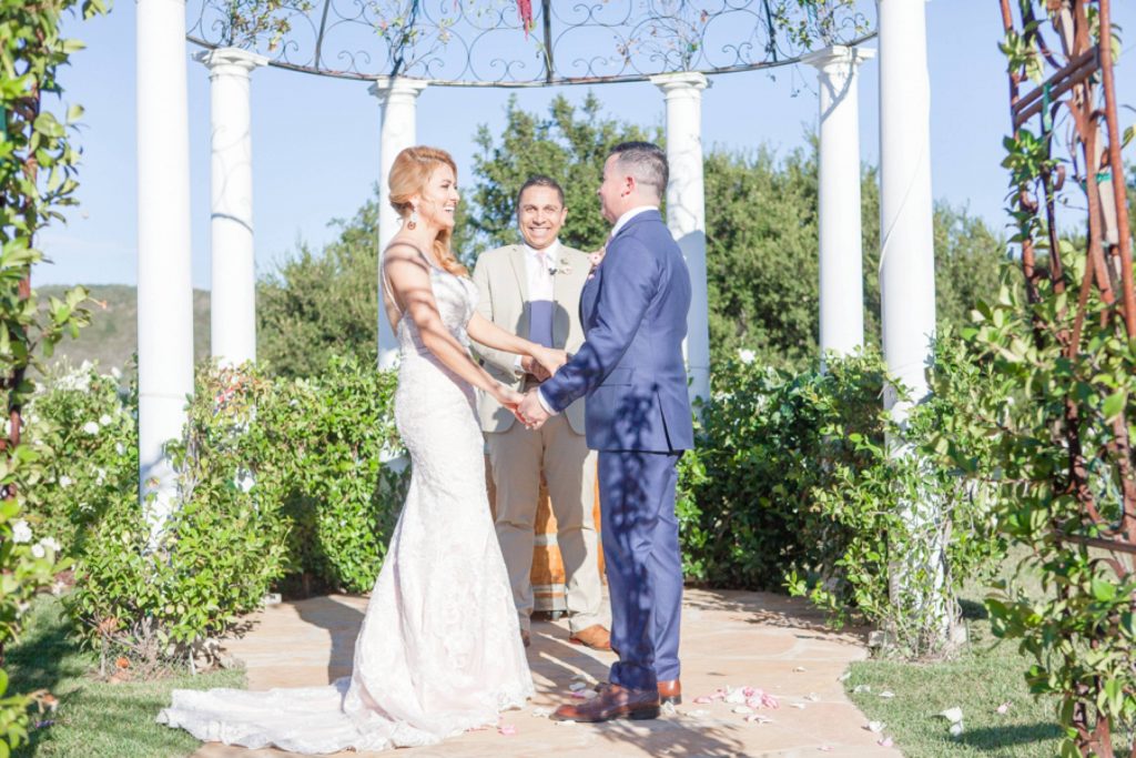 bride and groom exchange vows bride in lace gown with bouquet Forever and always Farm Johnathan and Bernice Temecula wedding photographer Carrie McGuire Photography