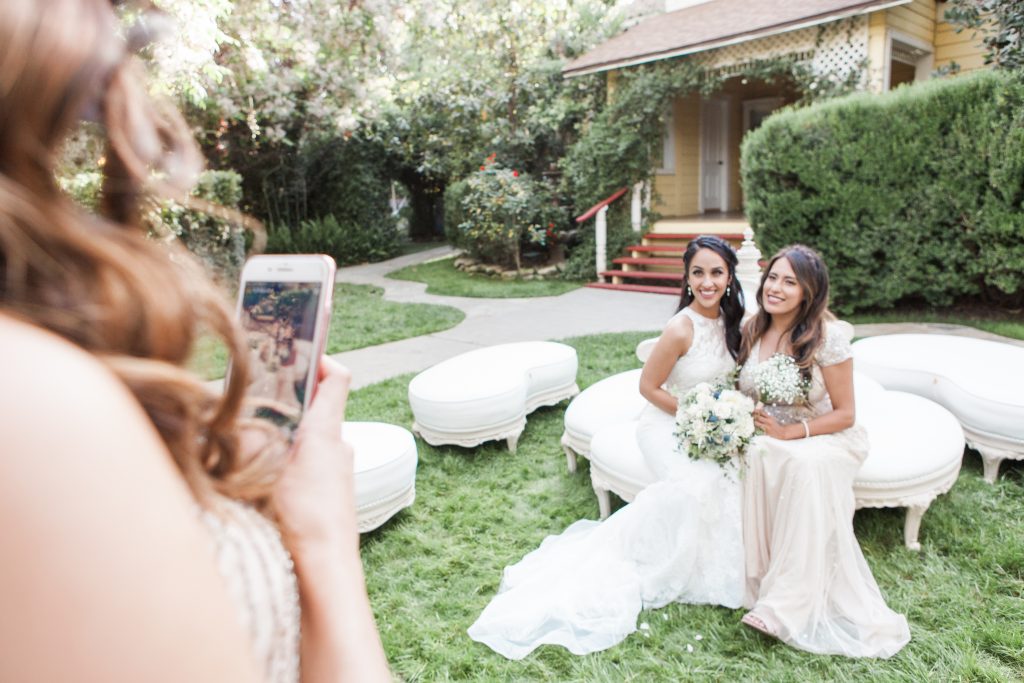 bride and bridesmaid getting a photo taken on a cell phone Carrie McGuire Photography Temecula wedding photographer