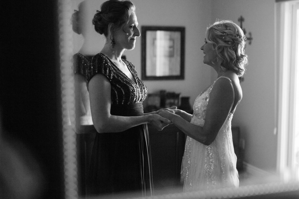 black and white bridesmaid and bride talking Meadowview backyard wedding Carrie McGuire Temecula wedding Photography 