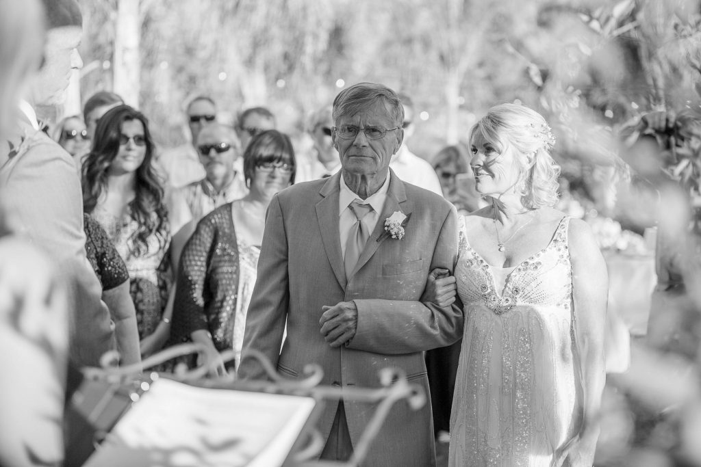 black and white father of the bride and bride walking down the isle Meadowview backyard wedding Carrie McGuire Temecula wedding Photography 