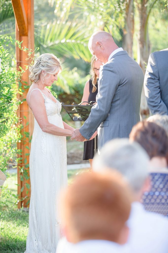 bride and groom praying at alter Meadowview backyard wedding Carrie McGuire Temecula wedding Photography 