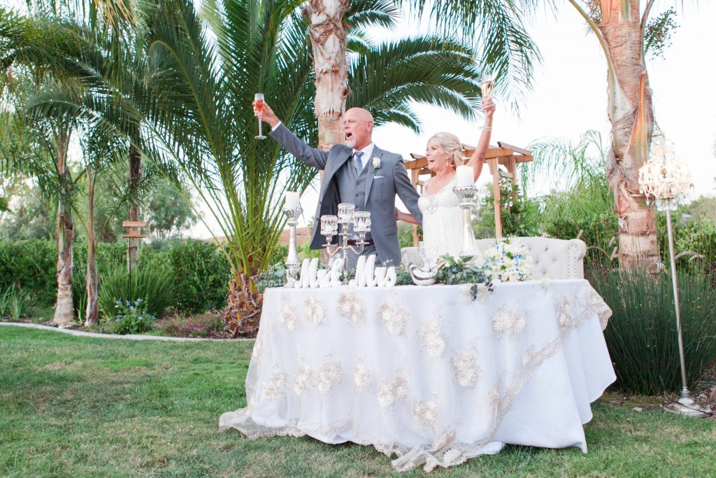 cheers from the bride and groom Meadowview backyard wedding Carrie McGuire Temecula wedding Photography 
