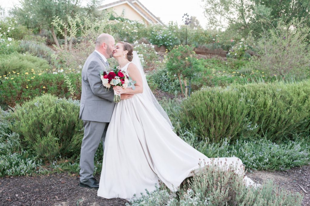 happy newly weds kissing in garden Wendy and Brian forever and always farm temecula wedding engagement photography Carrie McGuire photographer california