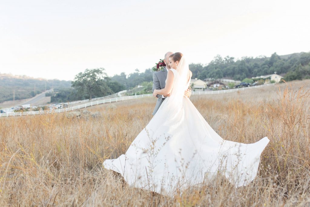 bride and groom embracing in field forever and always farm temecula wedding engagement photography Carrie McGuire photographer california
