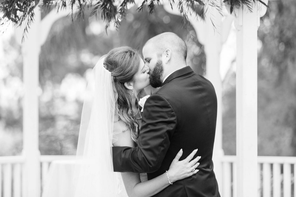 black and white photo of bride and groom first kiss Shadow Ridge Golf Club Temecula California wedding engagement maternity photography Carrie McGuire photographer California