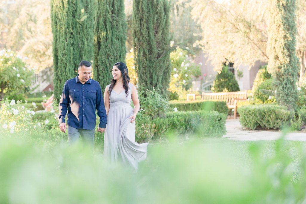 happy couple walking in garden Ponte Winery Temecula California wedding engagement photography Carrie McGuire photographer California