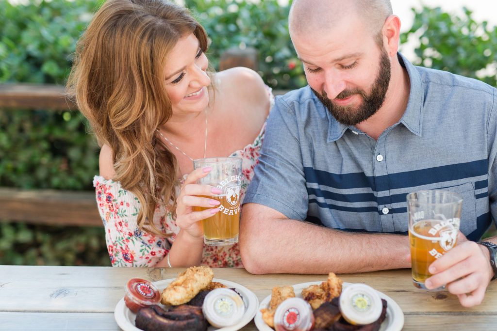 happy engaged couple enjoying beers and dinner belching beaver vista California Carrie McGuire Temecula wedding engagement Photography 