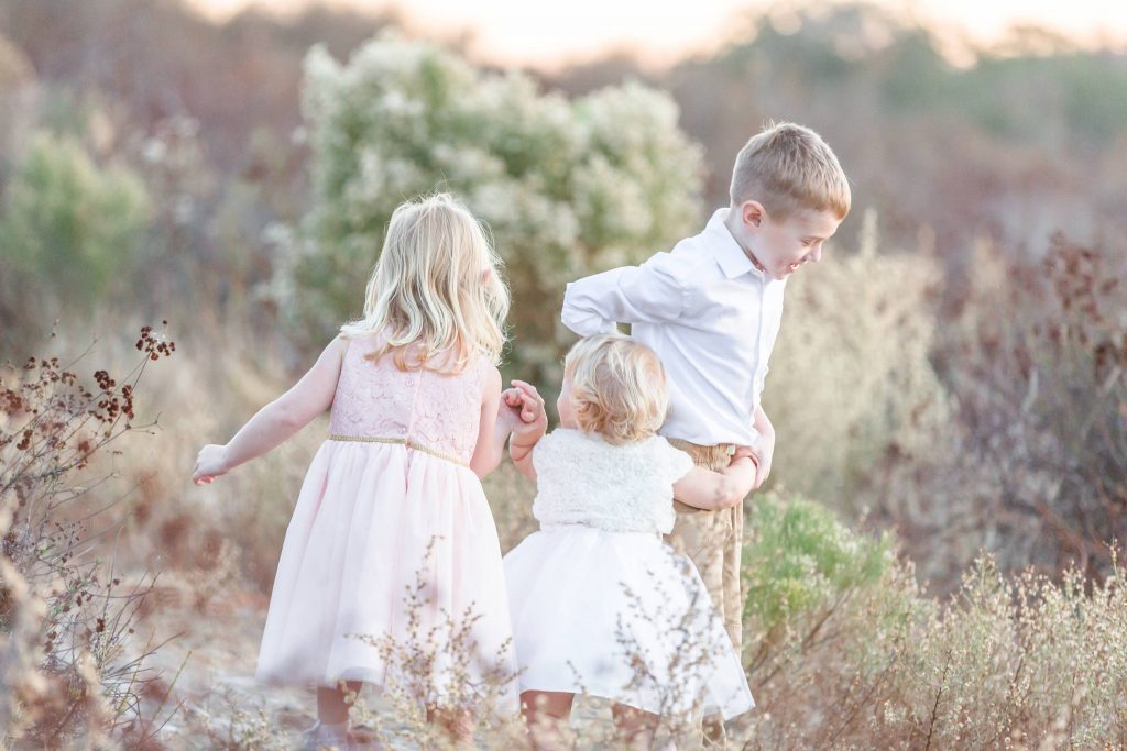 kids playing in field together Temecula California wedding engagement family maternity photography Carrie McGuire photographer