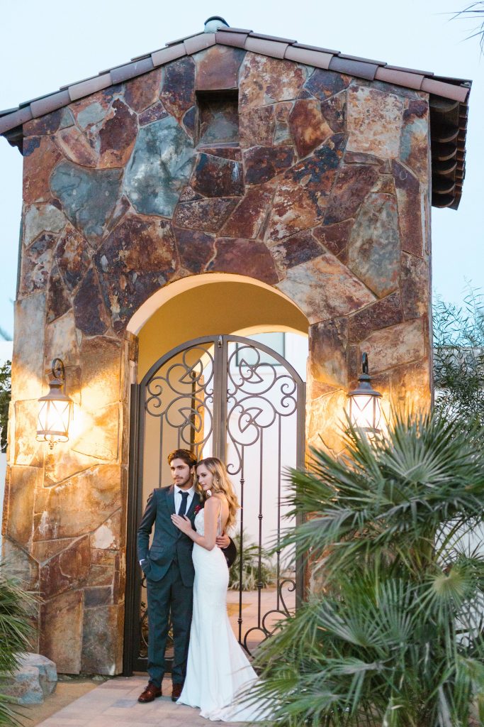 bride and groom and beautiful building Old El Polo Wedding Estate in Coachella Temecula california wedding Carrie McGuire photographer
