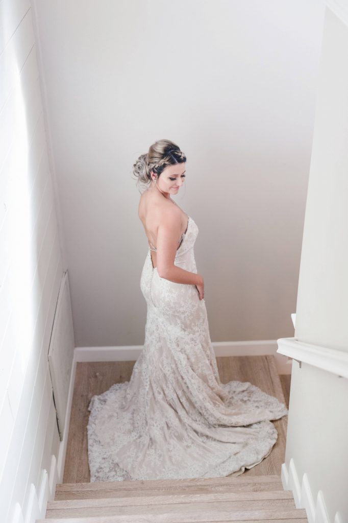 stunning bride posing on stairs in gorgeous lace gown Temecula Coachhouse California wedding engagement photography Carrie McGuire photographer California