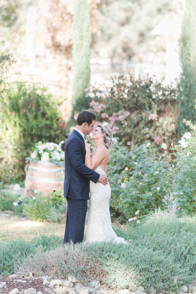 bride and groom in garden kissing Temecula Coachhouse California wedding engagement photography Carrie McGuire photographer California