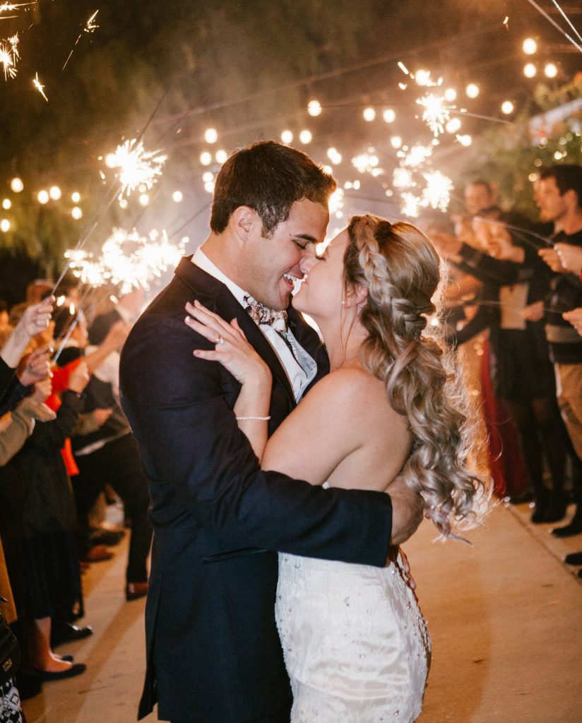 bride and groom happily embracing under sparklers Temecula Coachhouse California wedding engagement photography Carrie McGuire photographer California