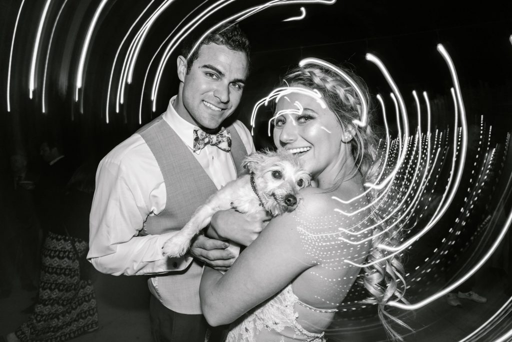 black and white photo of bride and groom and dog at reception Temecula Coachhouse California wedding engagement photography Carrie McGuire photographer California