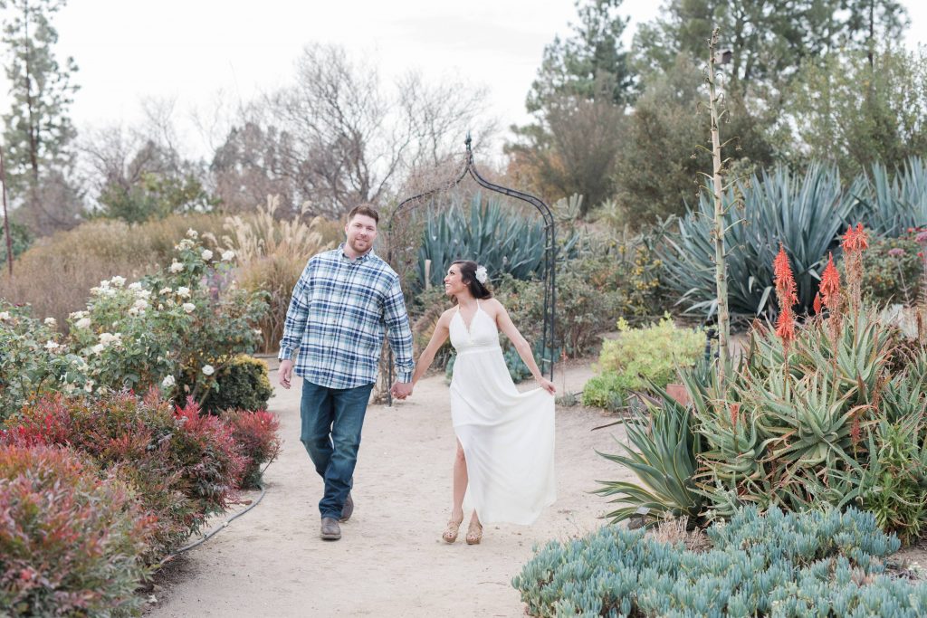 holding hands in garden Temecula wedding and engagement photographer session rose heritage gardens California wedding engagement photography Carrie McGuire California