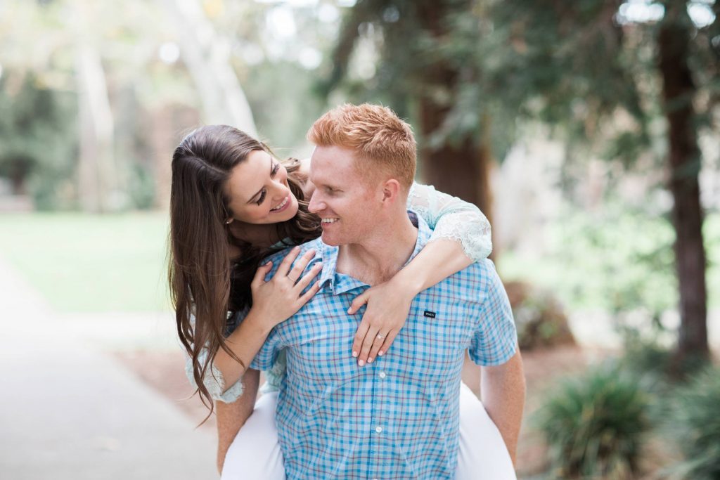engaged couple playing toghter at clairmont pomona college engagement session Temecula wedding photography engagement photos Carrie McGuire Photographer