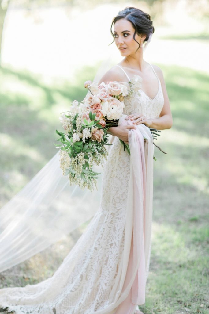 bride in lace wedding gown holding bouquet Temecula California wedding venues Orange County wedding engagement photography Carrie McGuire photographer California