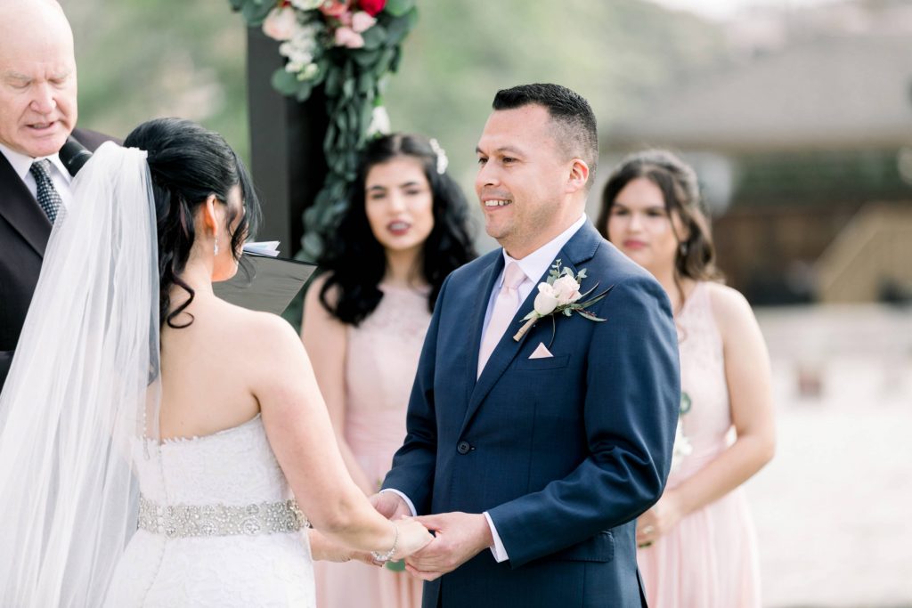 bride and groom exchange vows by a gorgeous lake Lakehouse Resort San Marcos Rachel and Steven Temecula California wedding engagement photography Carrie McGuire photographer California