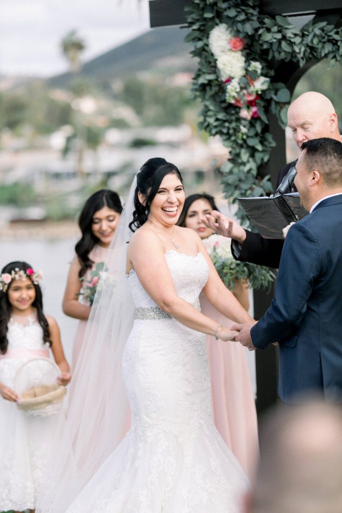 bride laughs during wedding ceremony Lakehouse Resort San Marcos Rachel and Steven Temecula California wedding engagement photography Carrie McGuire photographer California