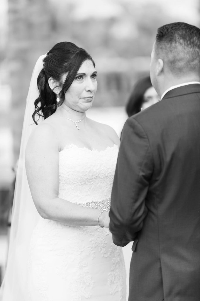 black and white photo of bride and groom exchanging vows Lakehouse Resort San Marcos Rachel and Steven Temecula California wedding engagement photography Carrie McGuire photographer California