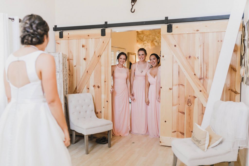 bridal party sees bride for the first time in her dress
