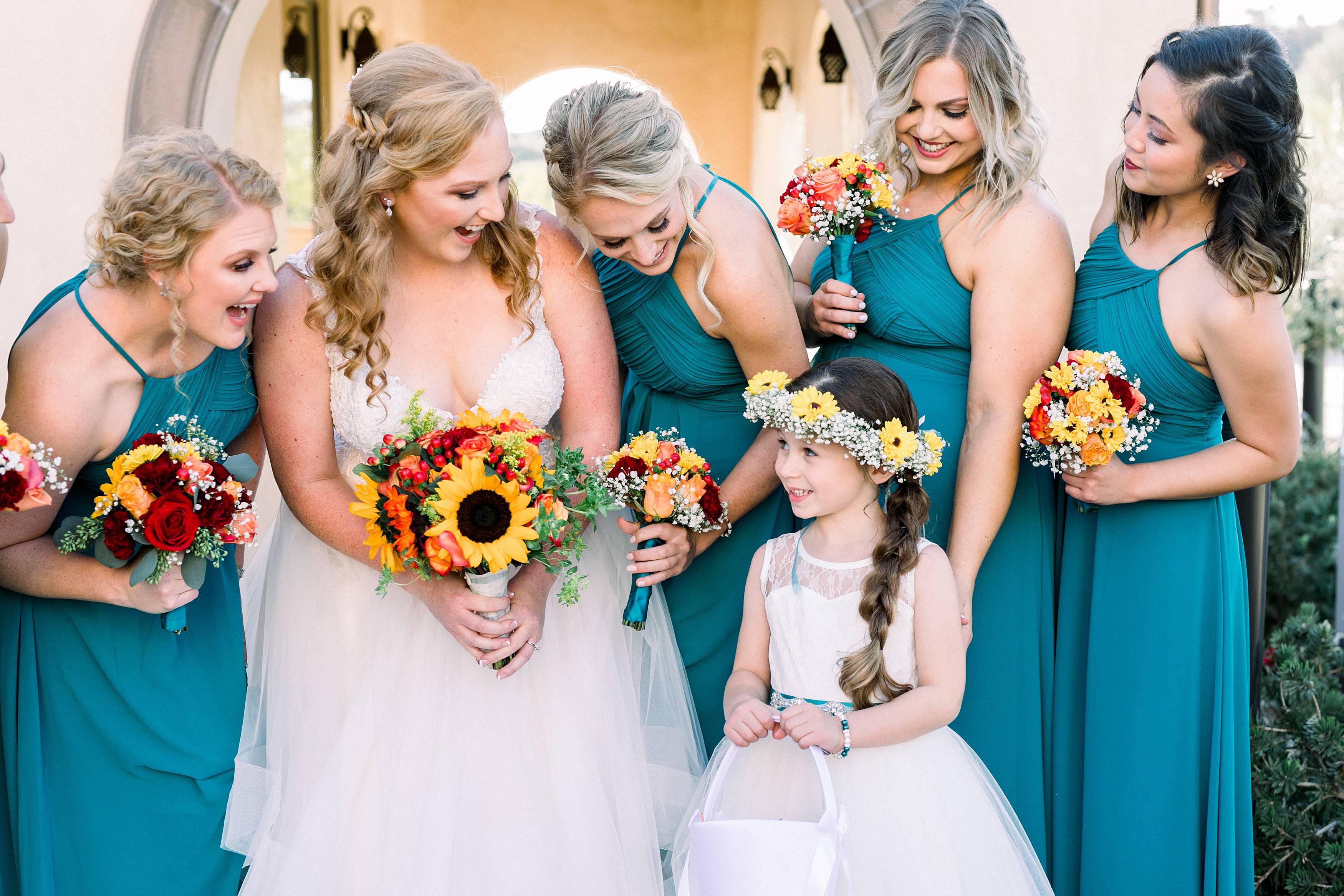 Bride with bridesmaids in teal dresses at Fazeli Cellars winery captured by Temecula Wedding Photographer Carrie Mcguire Photography